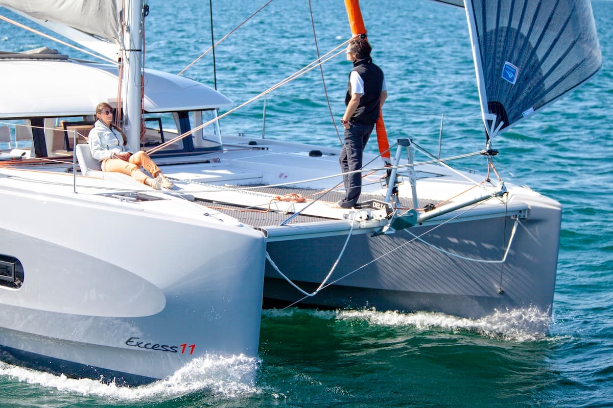 Excess 11 sailing with crew visible from the bow
